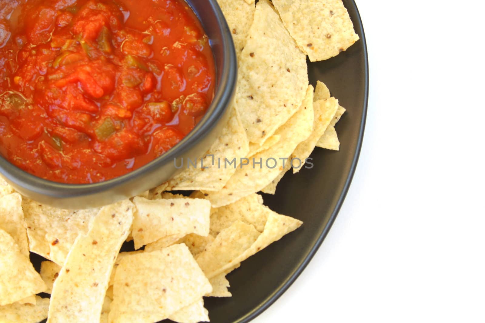 Salsa and chips isolated on a white background.