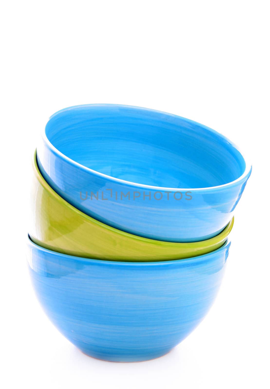 three colorful bowls stacked up and isolated on a white background.
