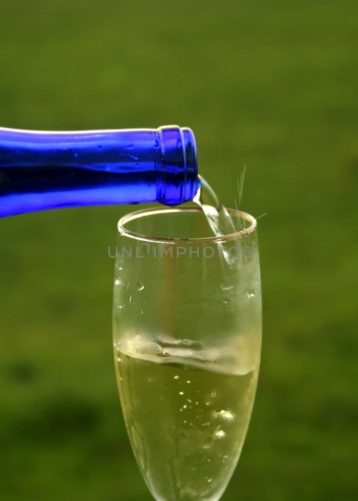 Pouring a glass of white wine outside.