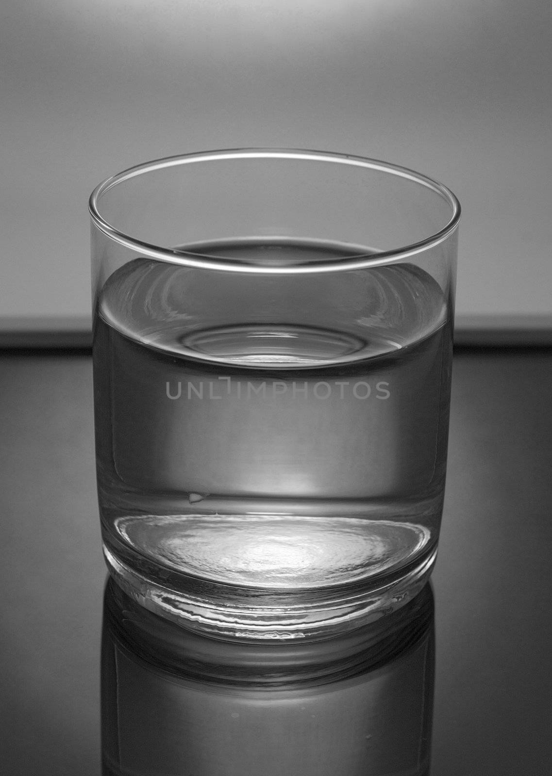 glass of water in mirror table, grayscale