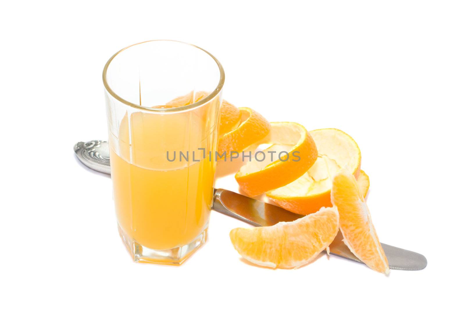 glass with orange juice and knife and orange segments and orange skin, isolated on white