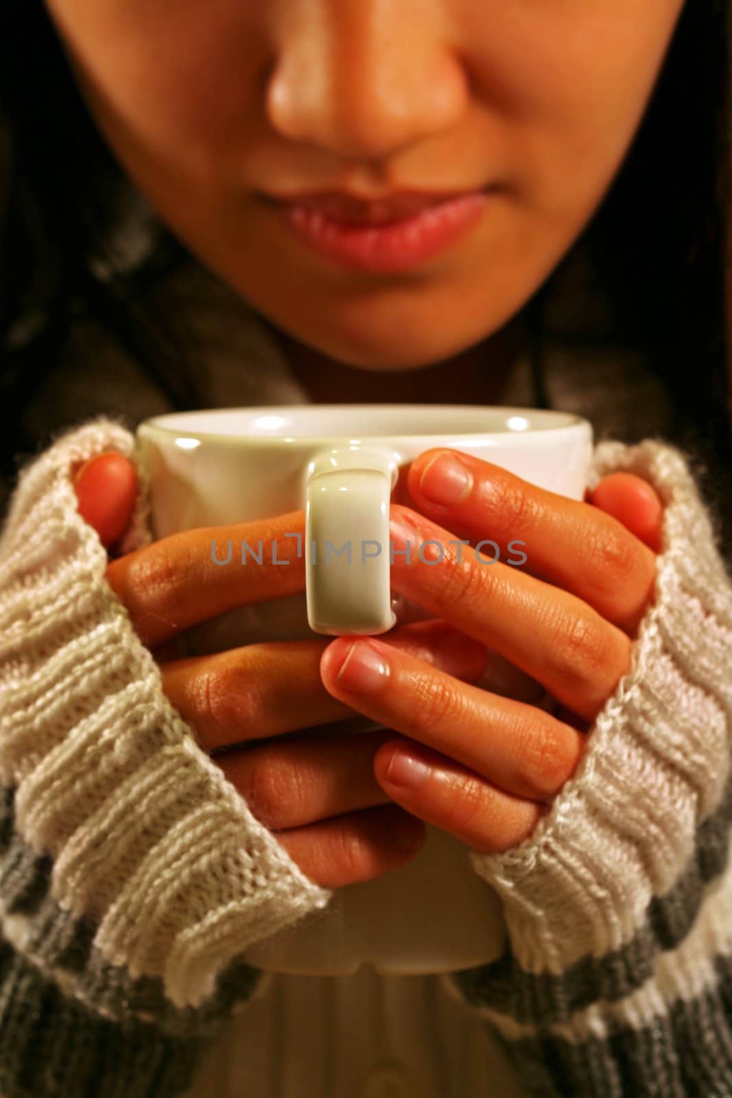 A woman holding a cup of coffee