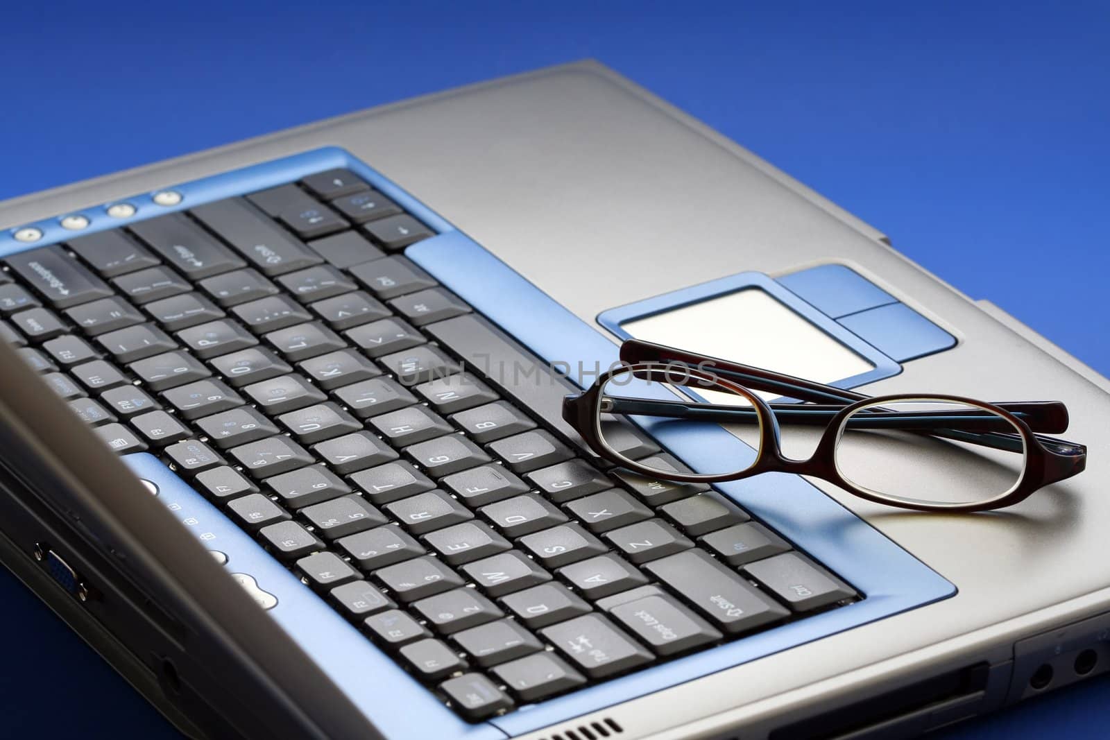 Glasses on laptop by aremafoto