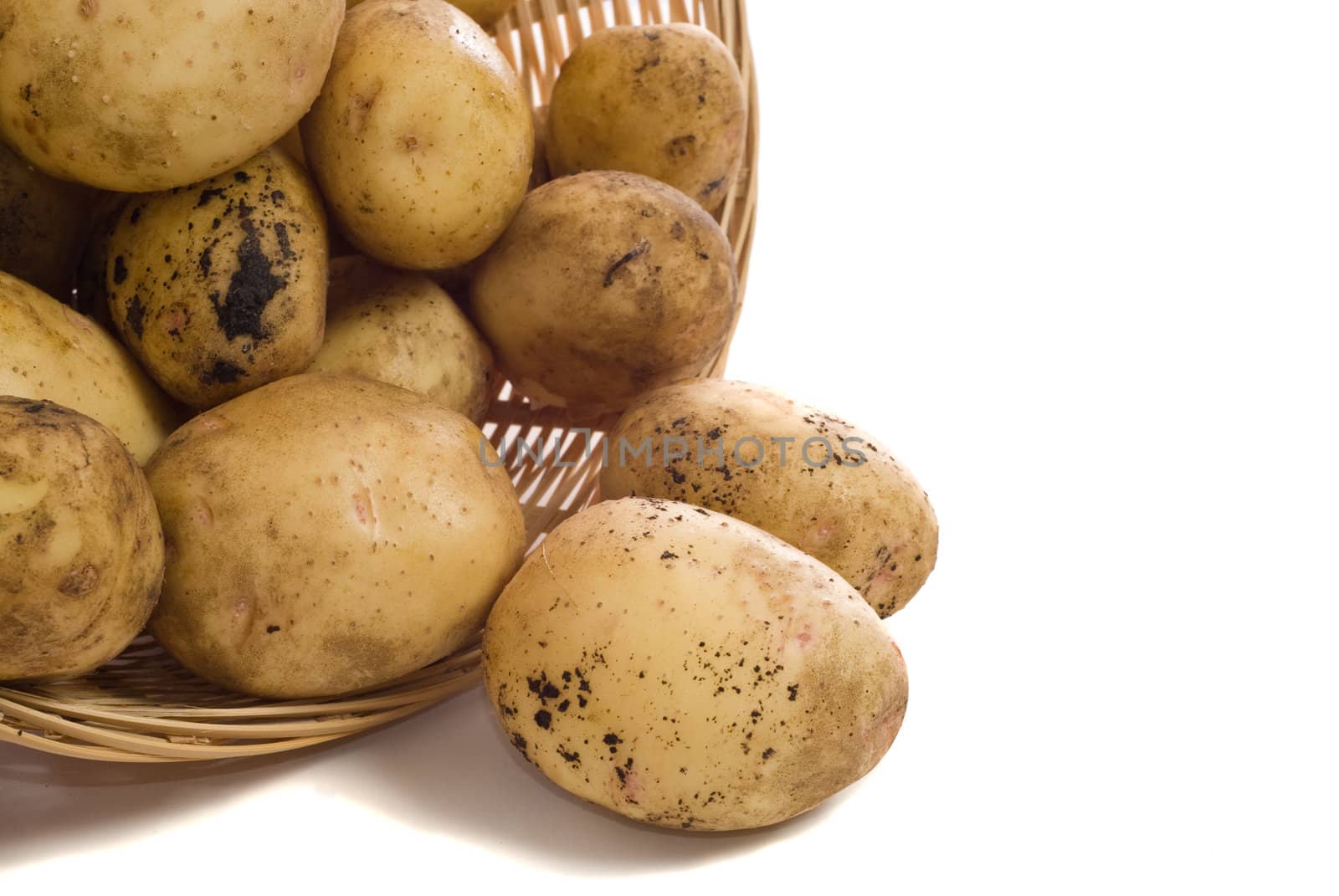 A pile of garden potatoes shot on a white background