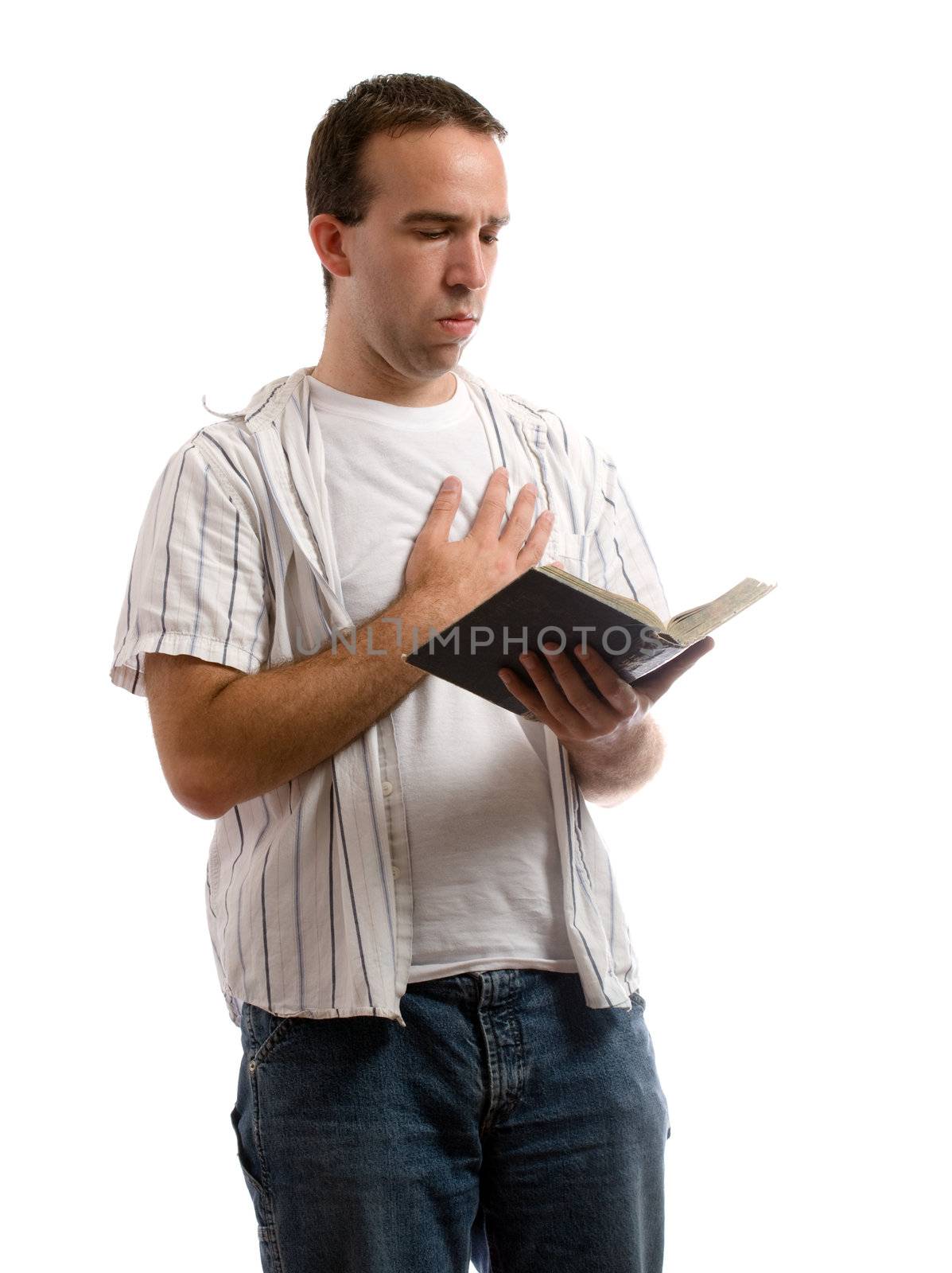 A young man holding an old bible is saying a prayer, isolated against a white background