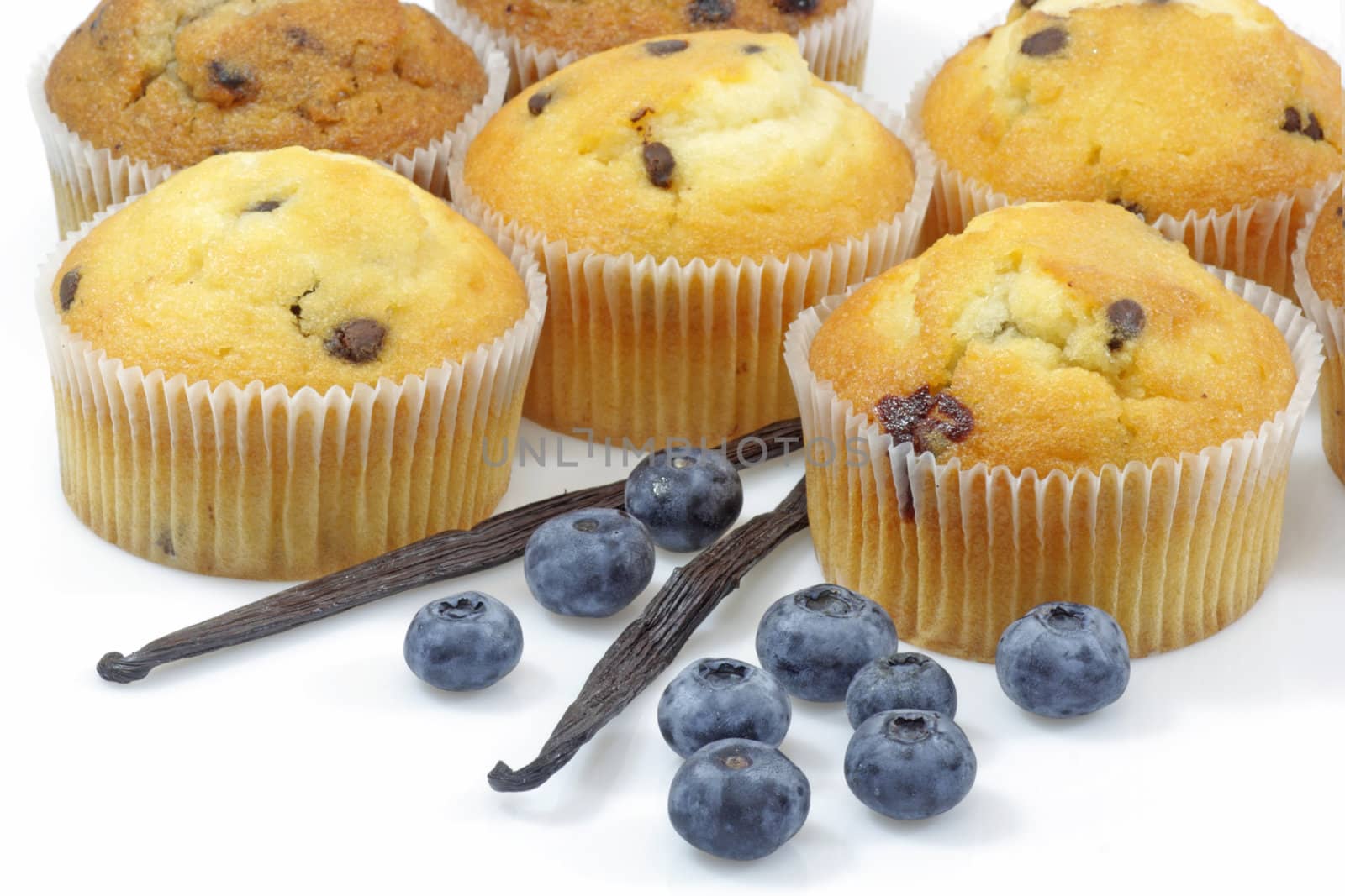 Muffins with blueberries on bright background