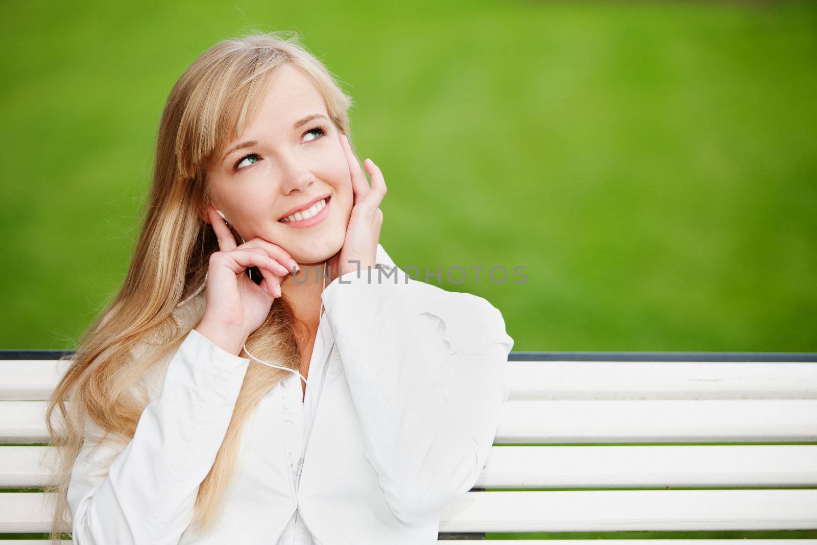 Young woman listening to the music outdoors