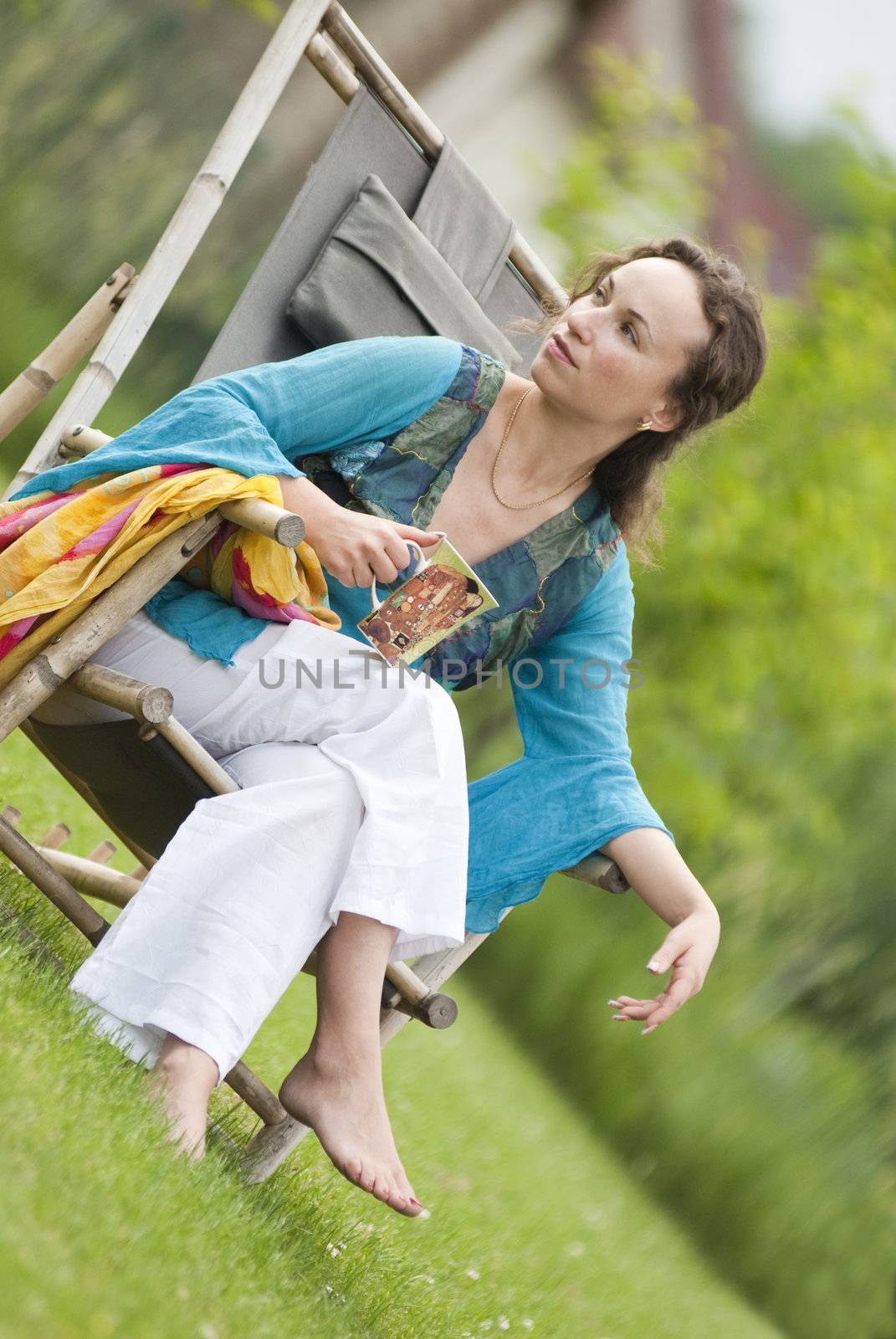 Young woman relaxing on a deck chair