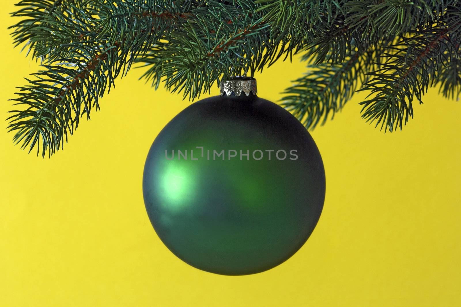 Decorative chrismas ball on yellow background