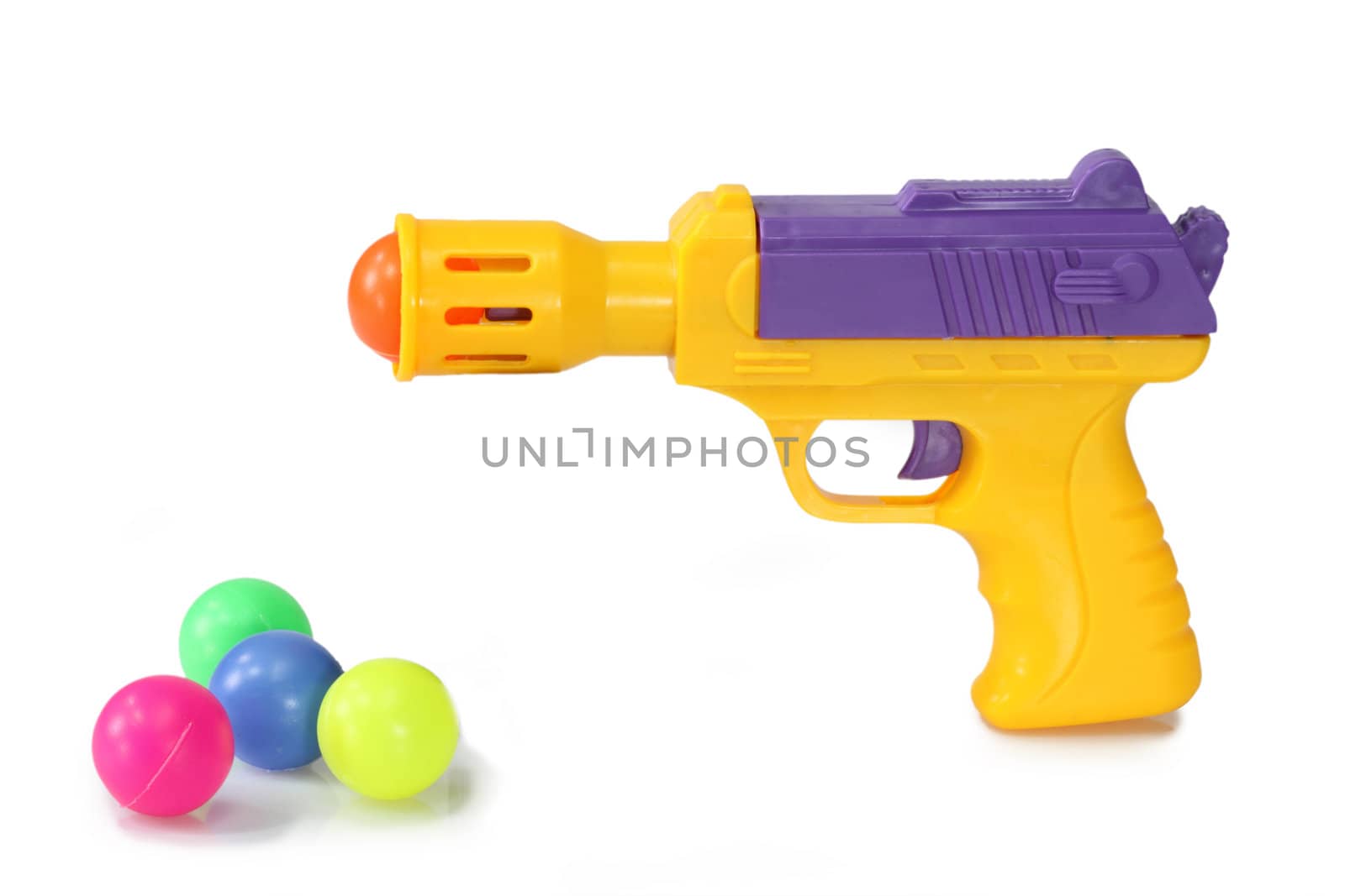Toy Gun with plastic balls  on white background
