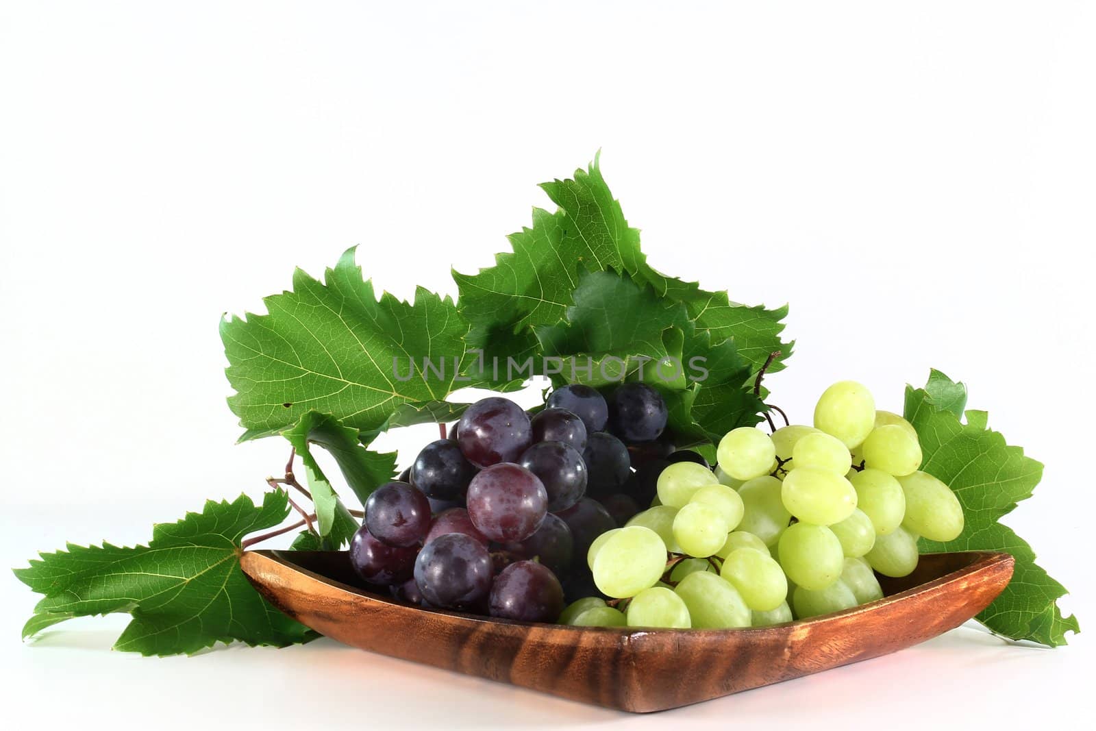 fresh grapes and leaves on a white background