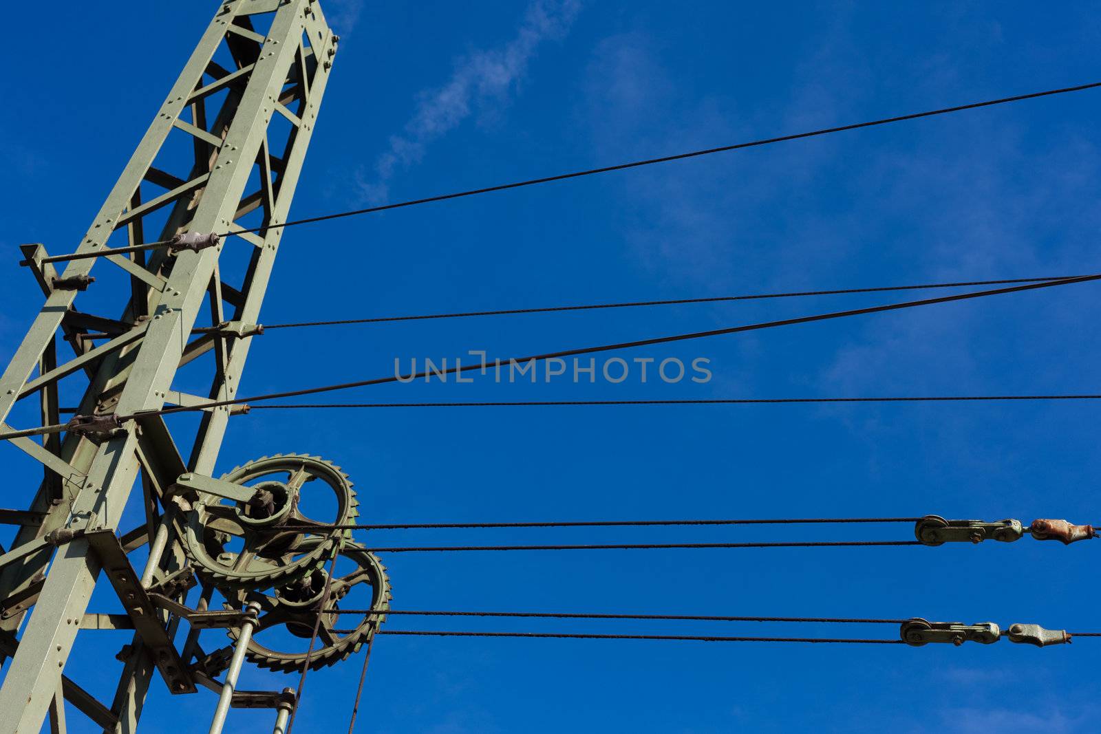 Overhead contact wires of electrified railway tracks kept under tension.