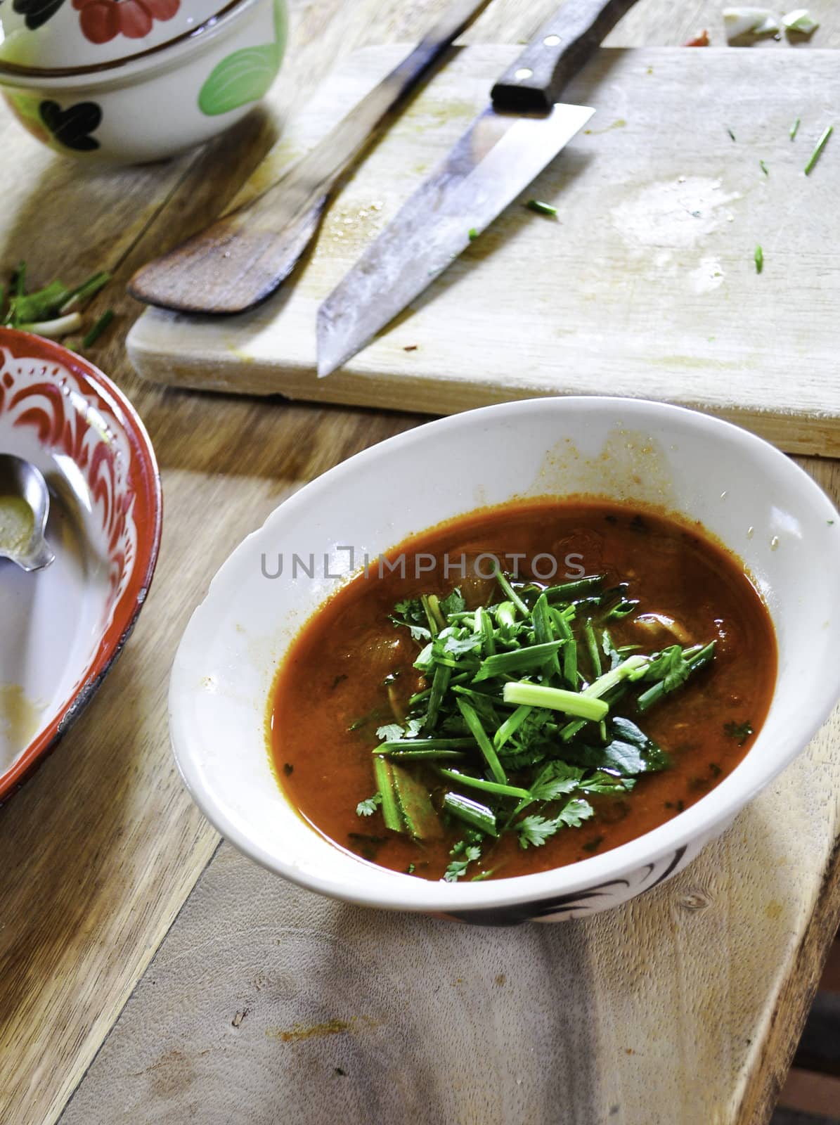 Traditional Thai cuisine of Tom Yum soup made outdoors at a cooking school