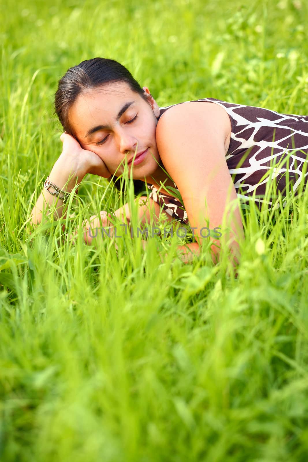 Young woman resting in green meadow