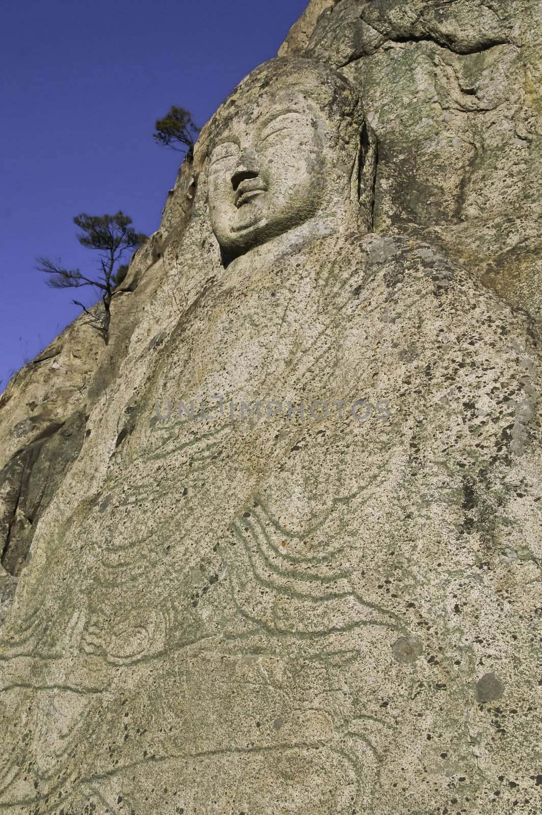Ancient stone buddha carved into a hillside in Korea