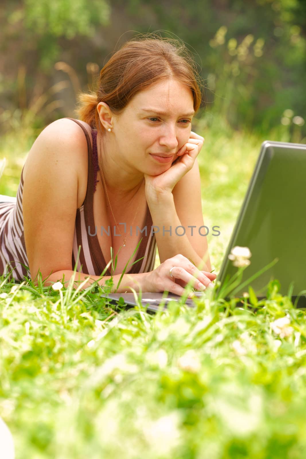 Young woman using her laptop outdoors.