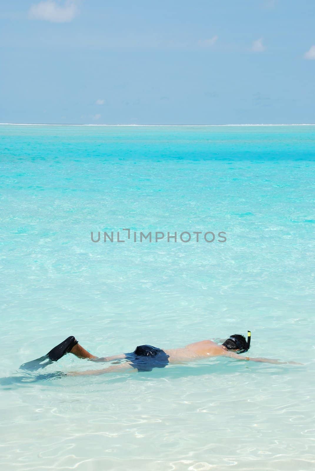 Young man snorkeling in Maldives (blue ocean water) by luissantos84