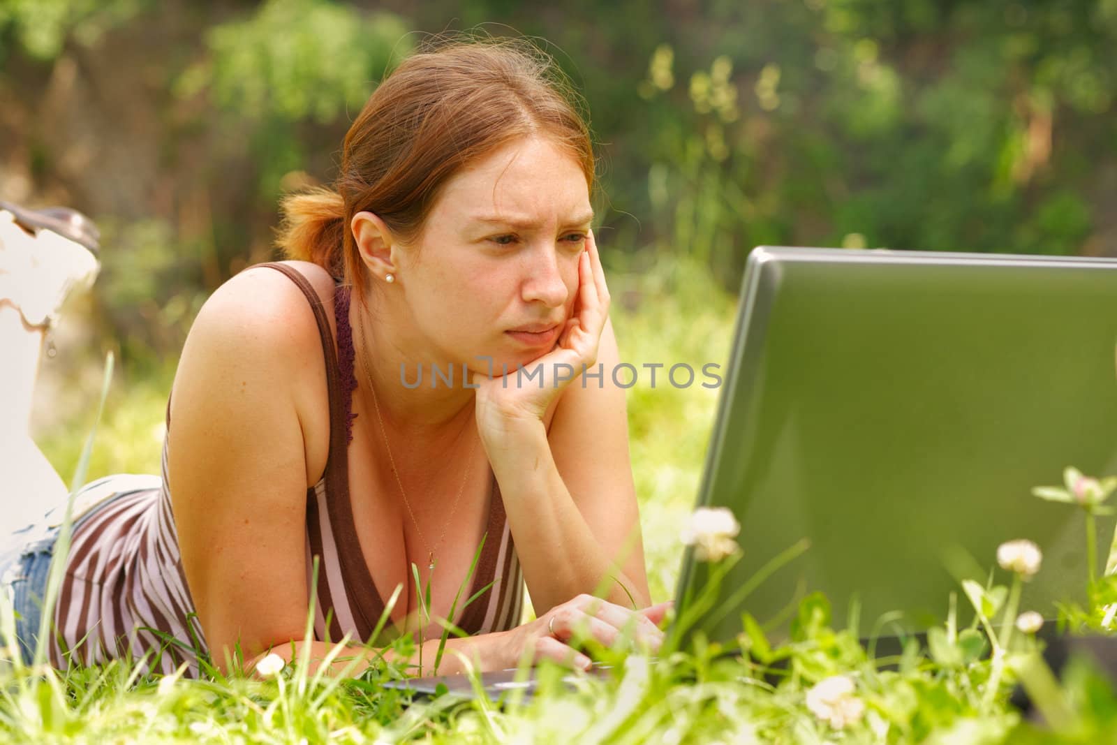 Young woman using her laptop outdoors.