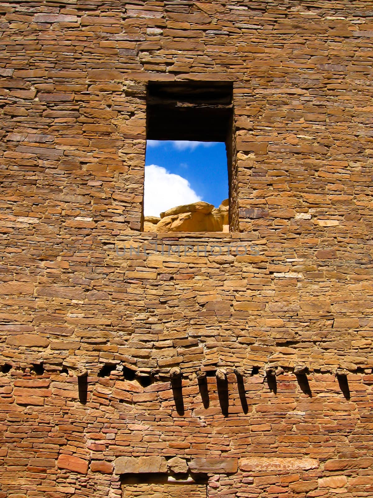 Ruin wall with window opening of laid sandstone bricks of pueblo bonito in chaco canyon, New Mexico, USA, the centre of sunken Anasazi Culture of ancestral native Americans.