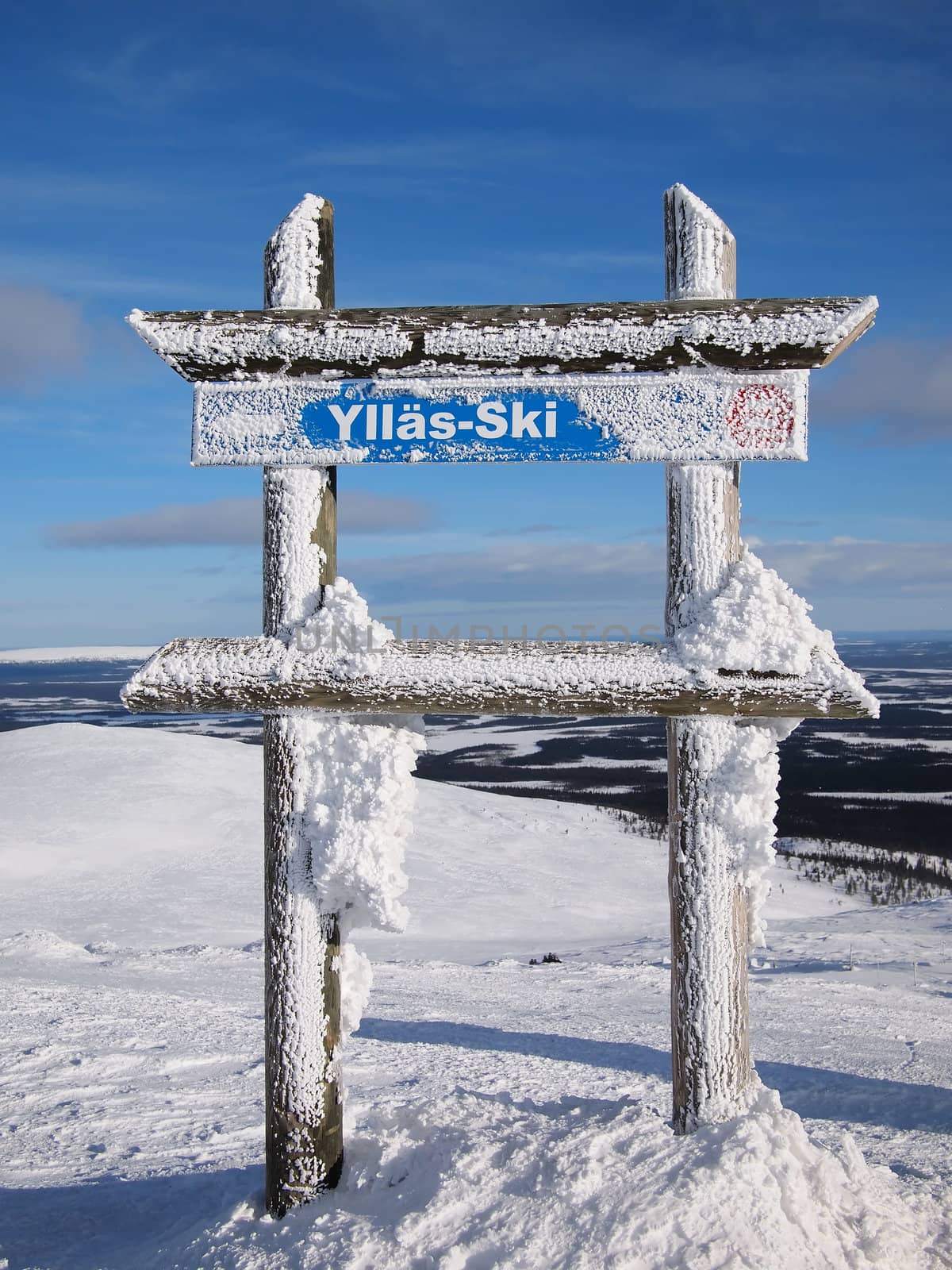 Piste sign of the skiing hill of Yll�s with a Lapland background.