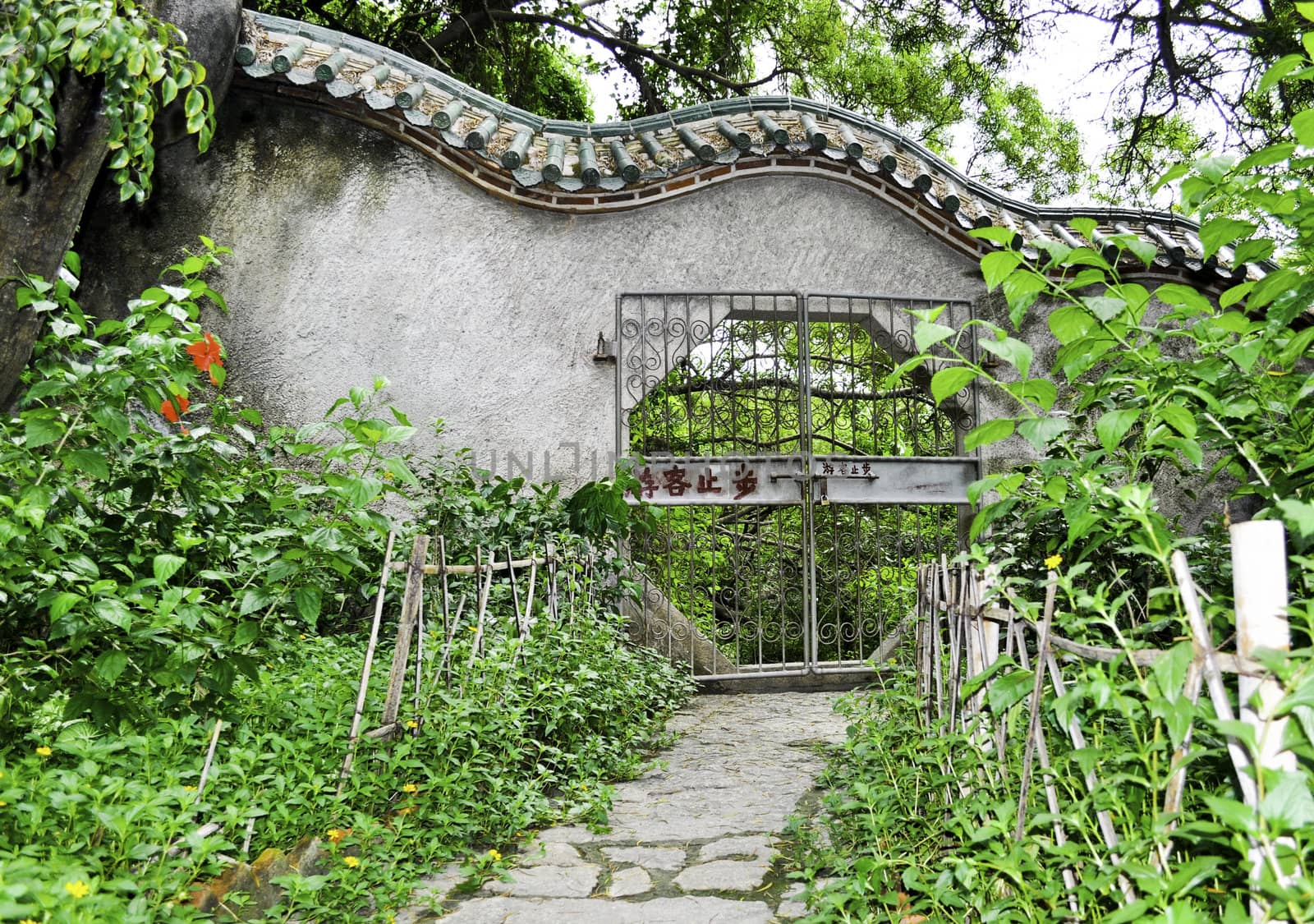 A chinese style gate in a park outside a buddhist temple