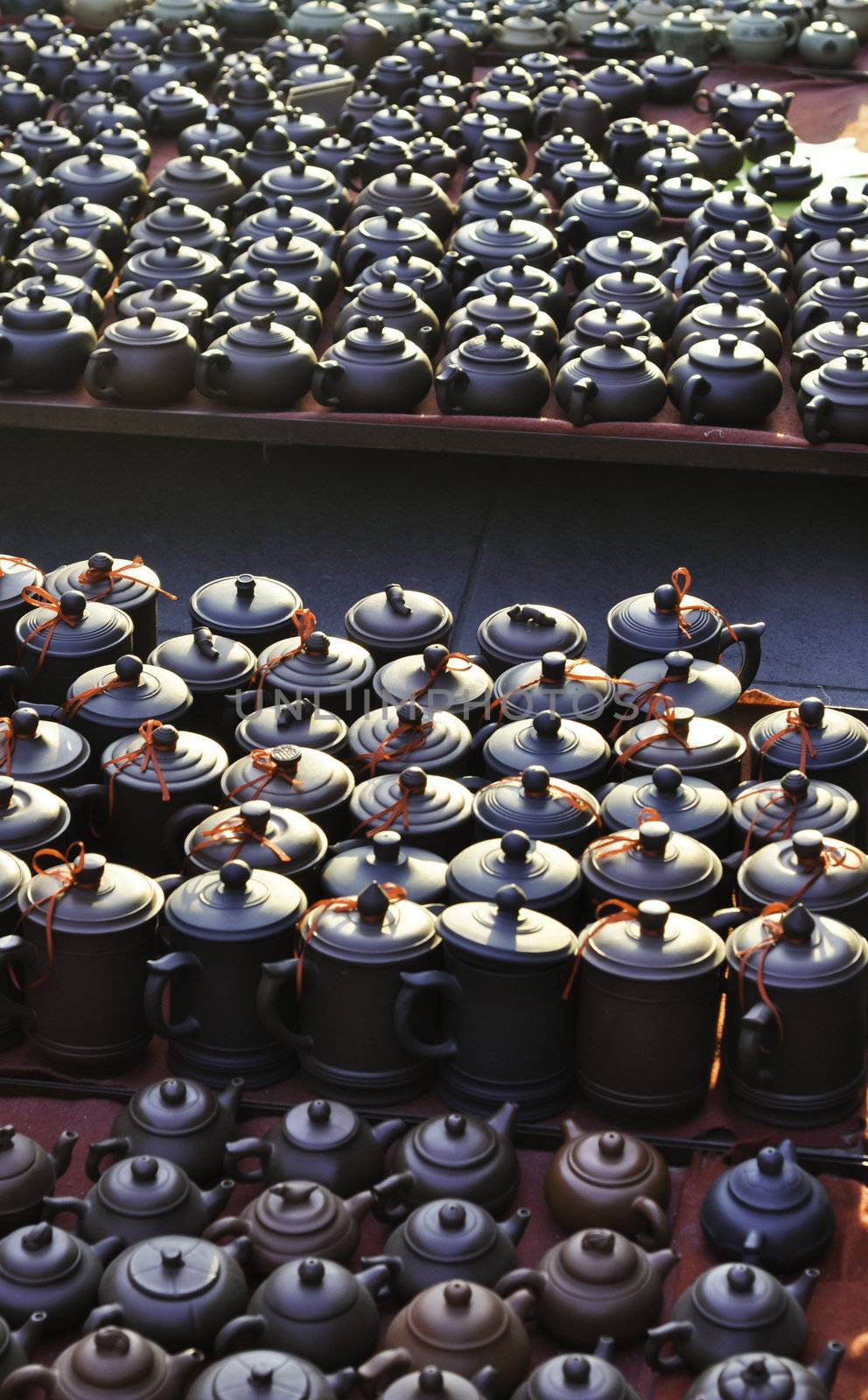 Various chinese teapots and pots for sale in a market