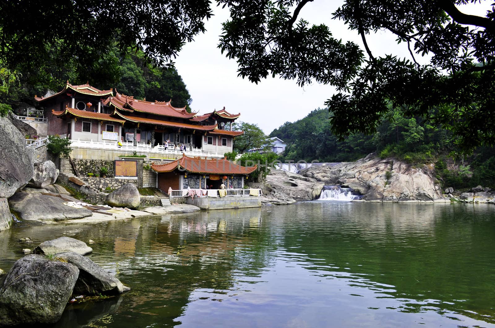 Buddhist temple in china located in the mountains over a river