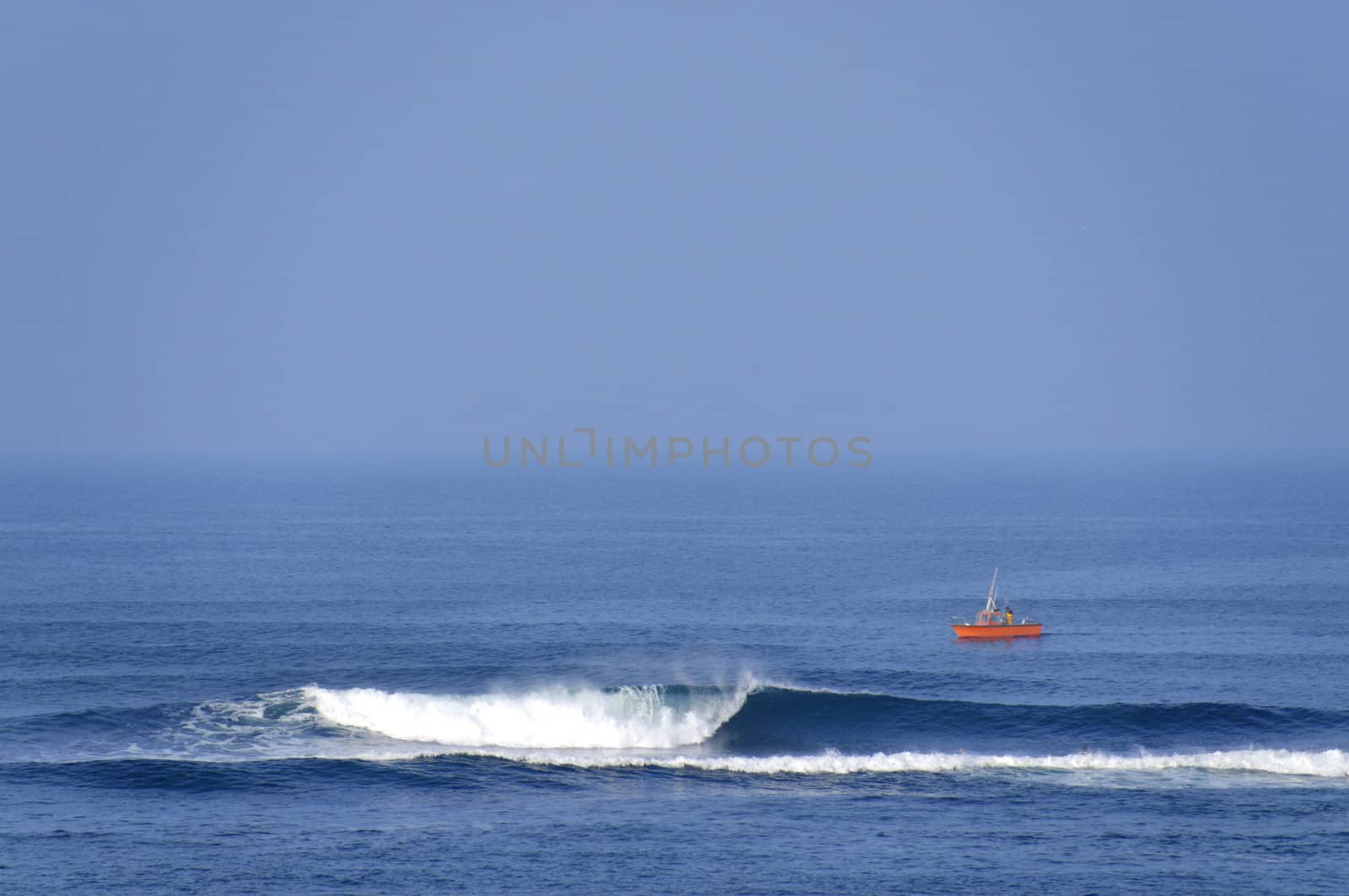 A self fish man on an orange boat