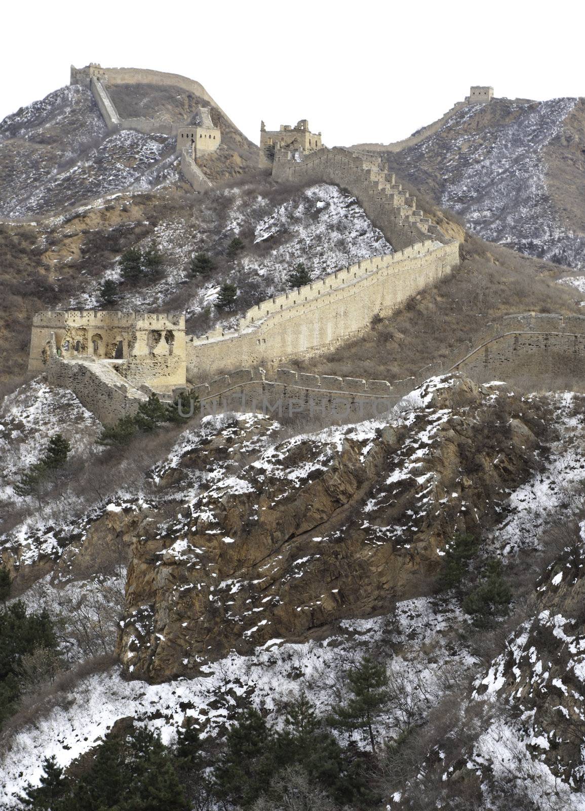 Distant view of the great wall of china with snow on the mountain