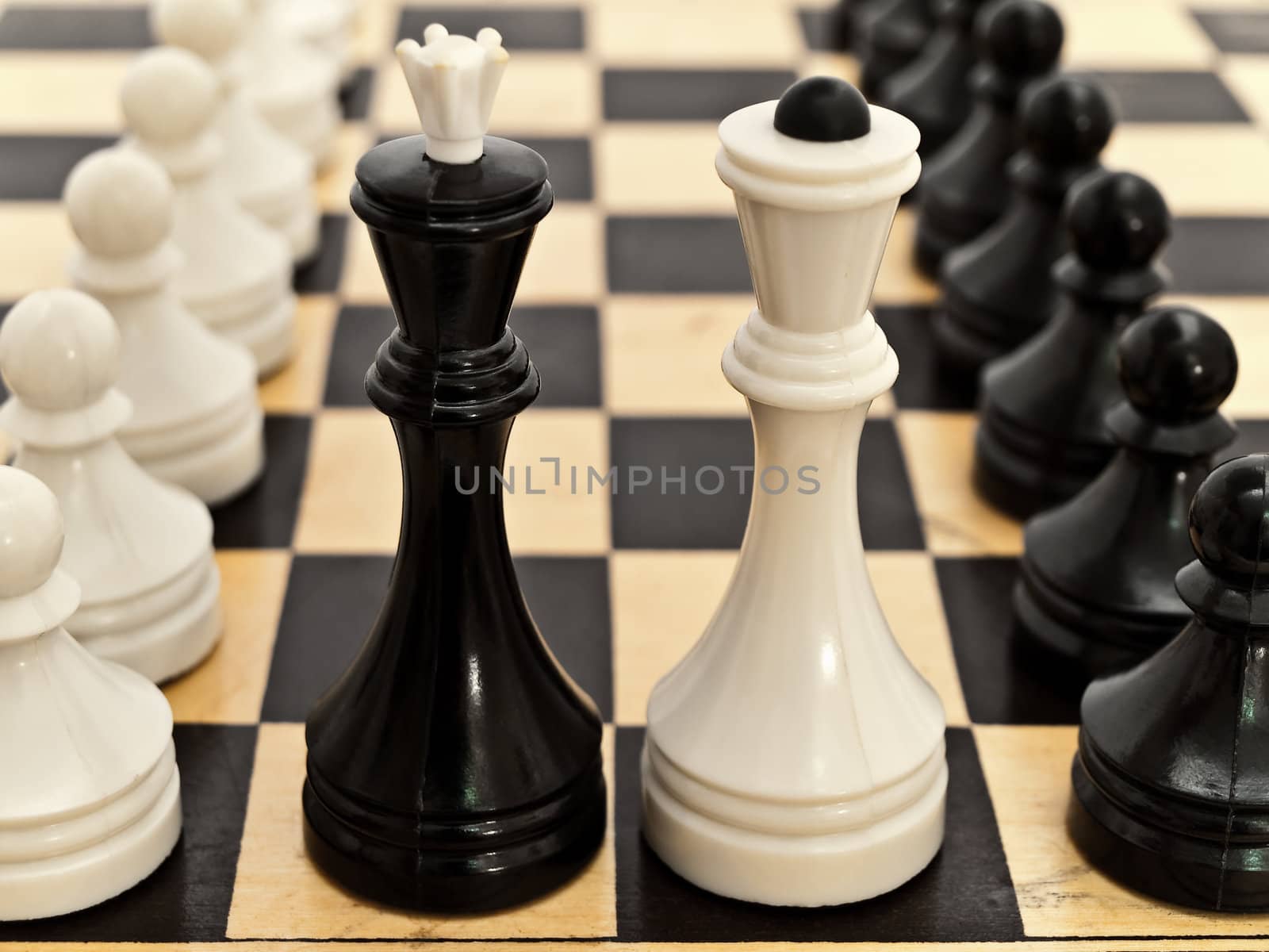 photo of the chessboard with black and white pawns on it