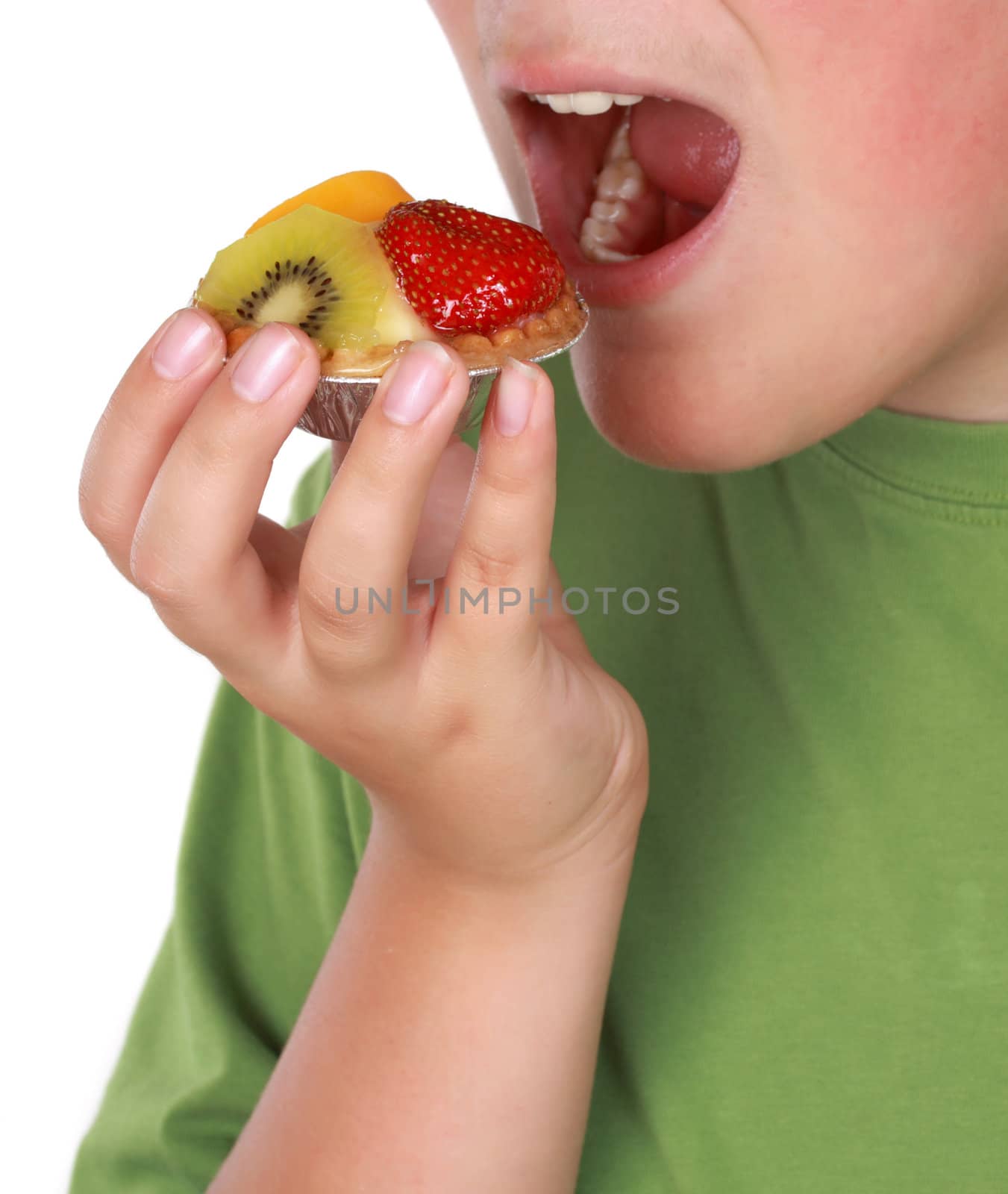 teen boy eating a fruit tartlet, white background