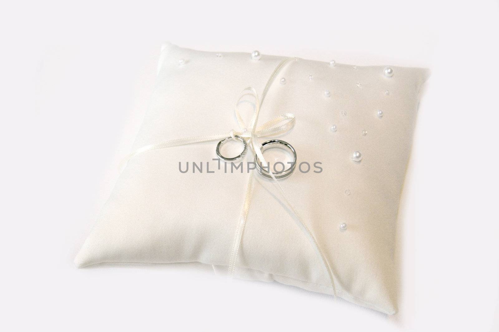 wedding rings on a pillow in silver