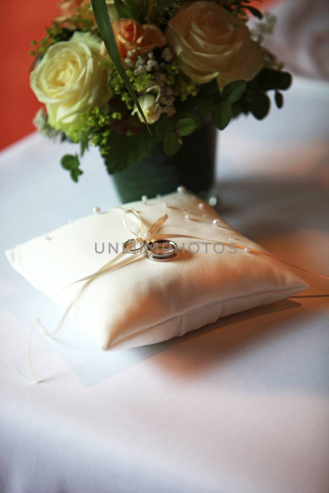 wedding rings on a pillow in silver