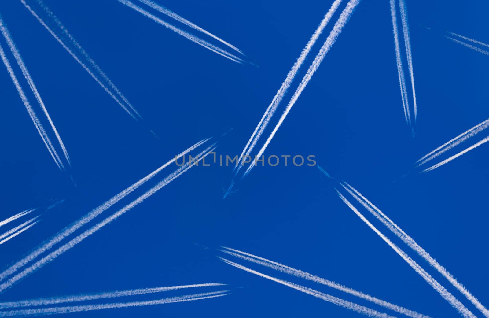 Heavy traffic: airliners criss-crossing the blue sky.