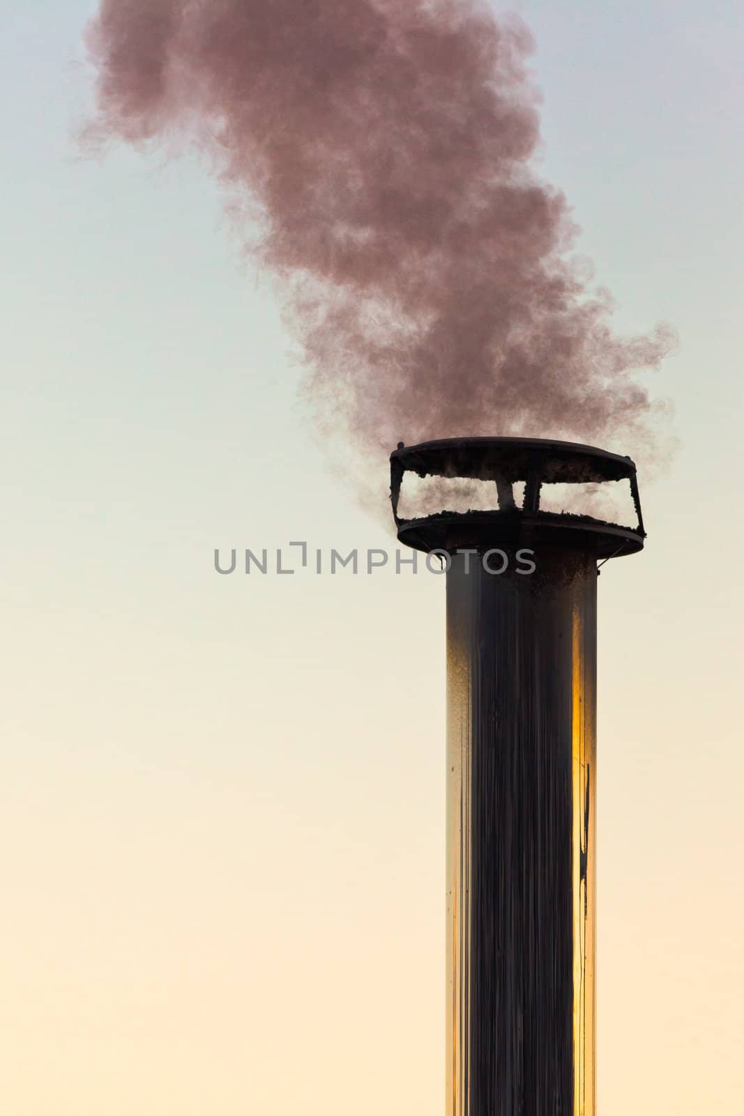 Black smoke emission from chimney polluting the environment.