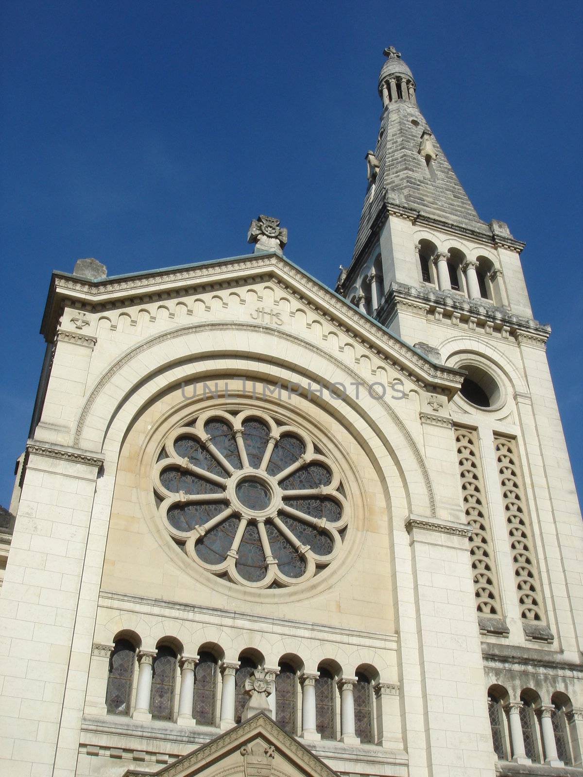 Facade of catholic roman paris church by beautiful weather