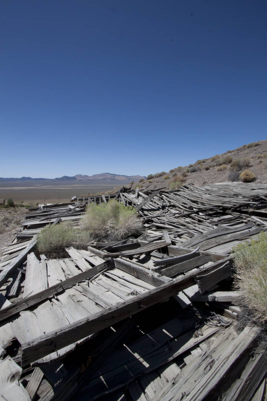 An old collapsed shack in the desert.