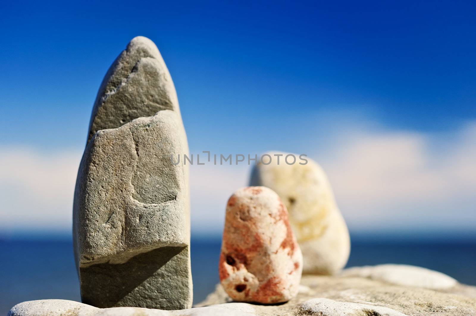 Three different pebble stand on the cliff