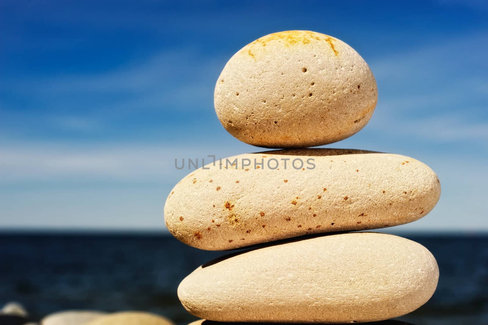 Three white massive cobblestone stand against the background of sky