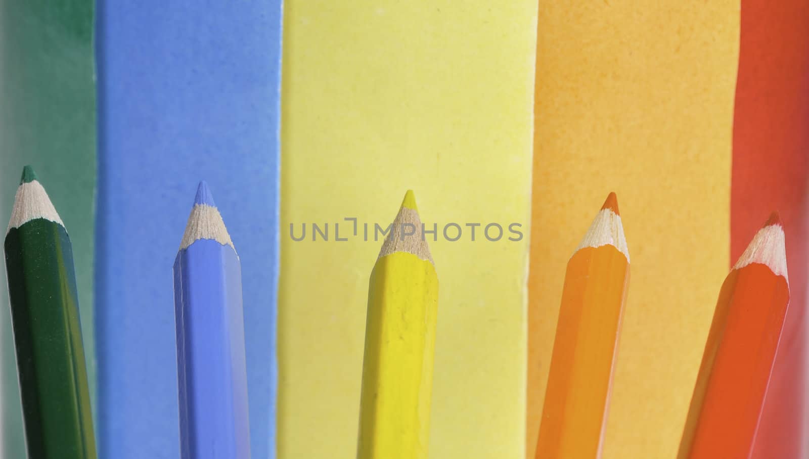 A colorful pencil crayons and scrapbooking papers ready for creative use.