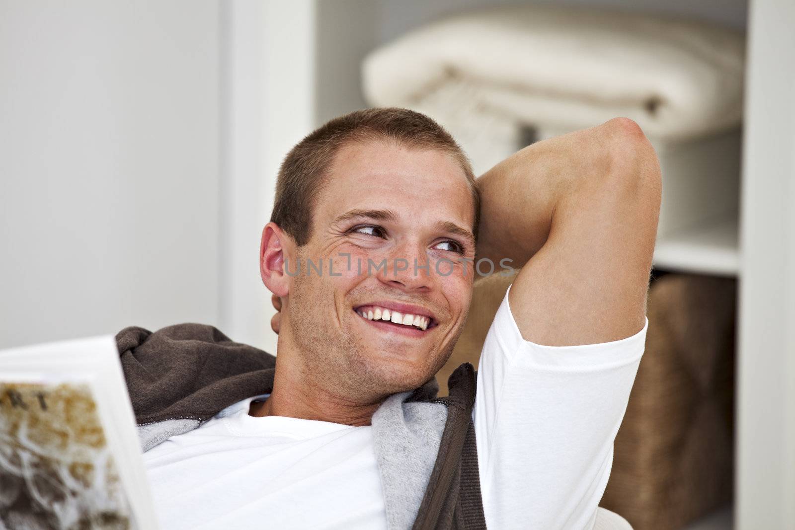 smiling young man reading a book