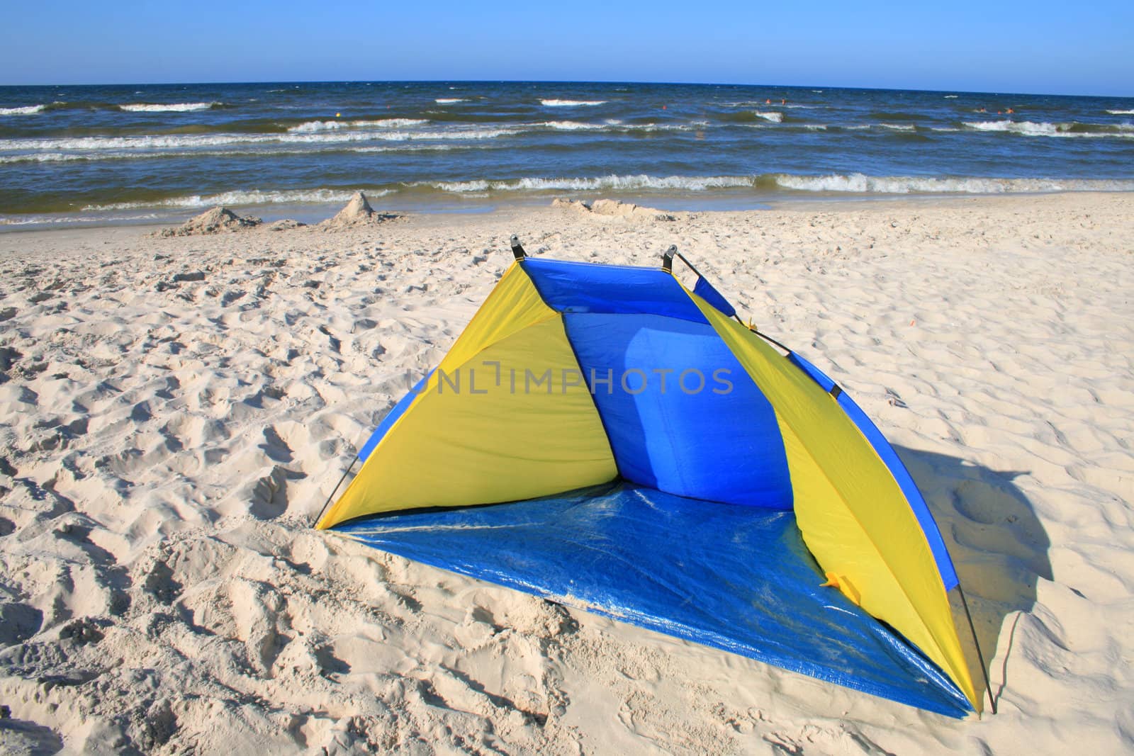Blue-yellow tent on the beach
