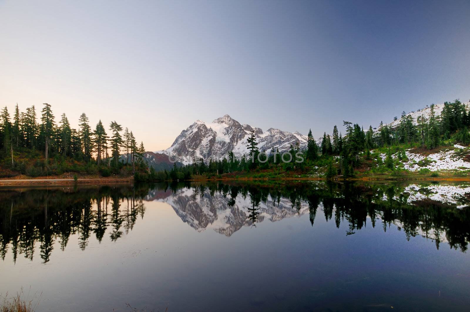 Mt Shuksan after sunset on a clear day projecting a crystal clear mirror image on picture lake