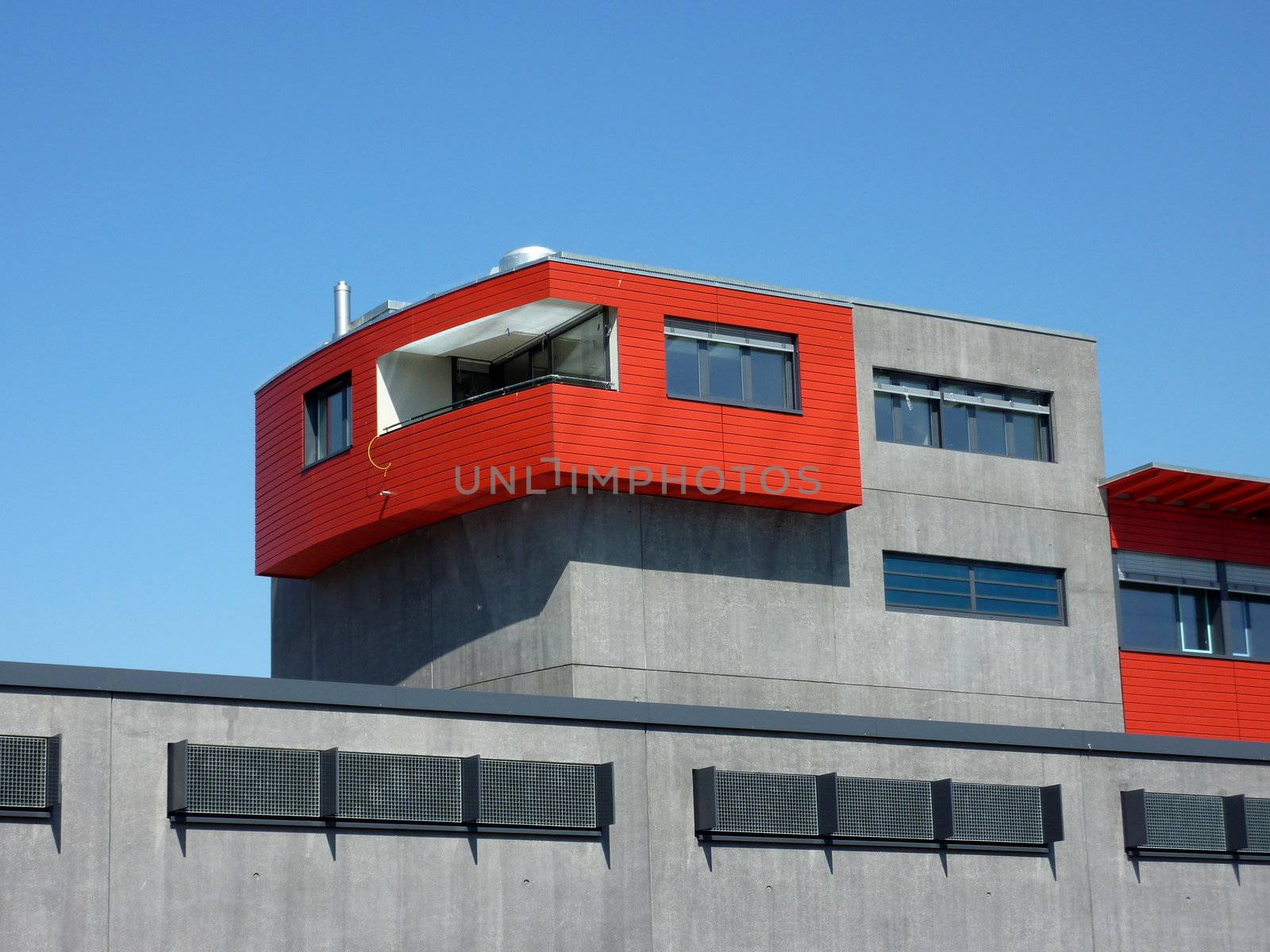 Red and grey modern building by beautiful weather