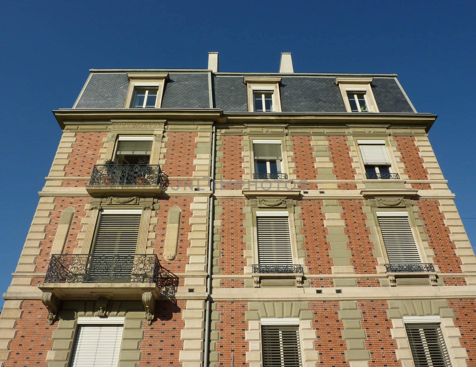 Facade of old red building by beautiful weather