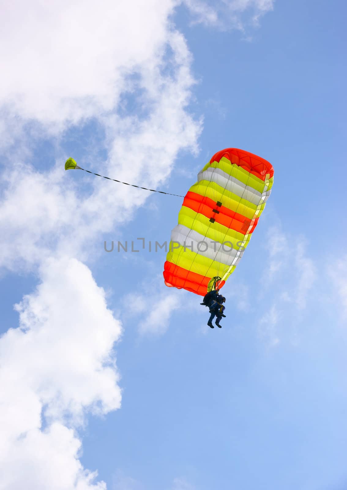 Tandem skydive parachute against a blue sky