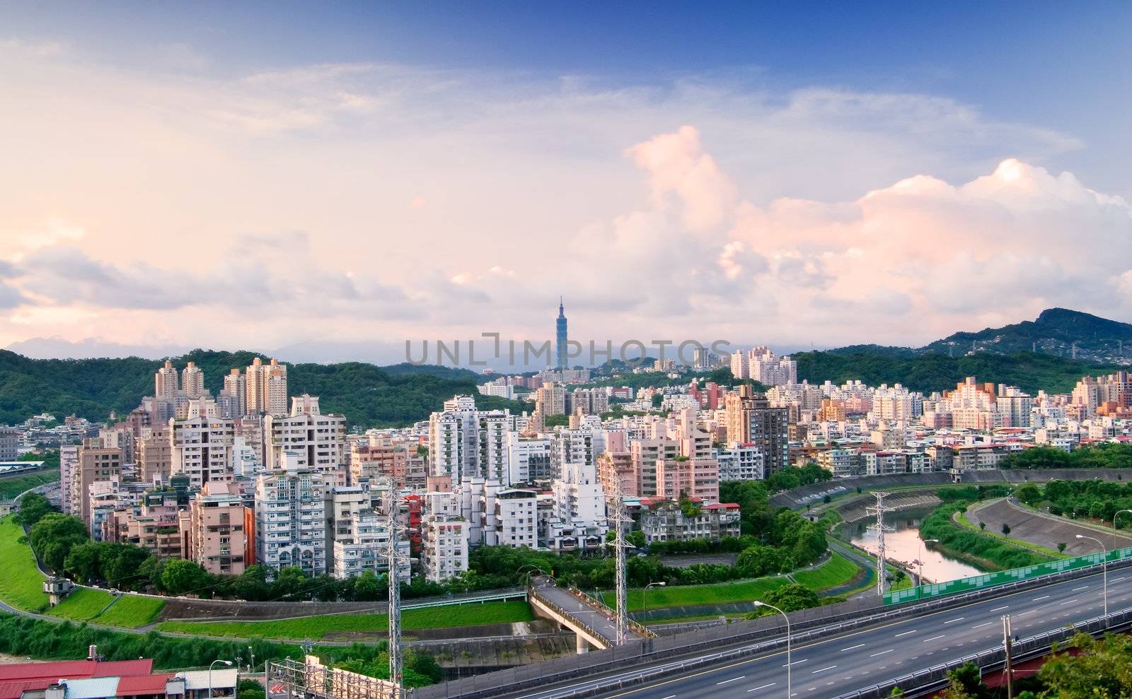 It is a cityscape photo of apartments and highway.