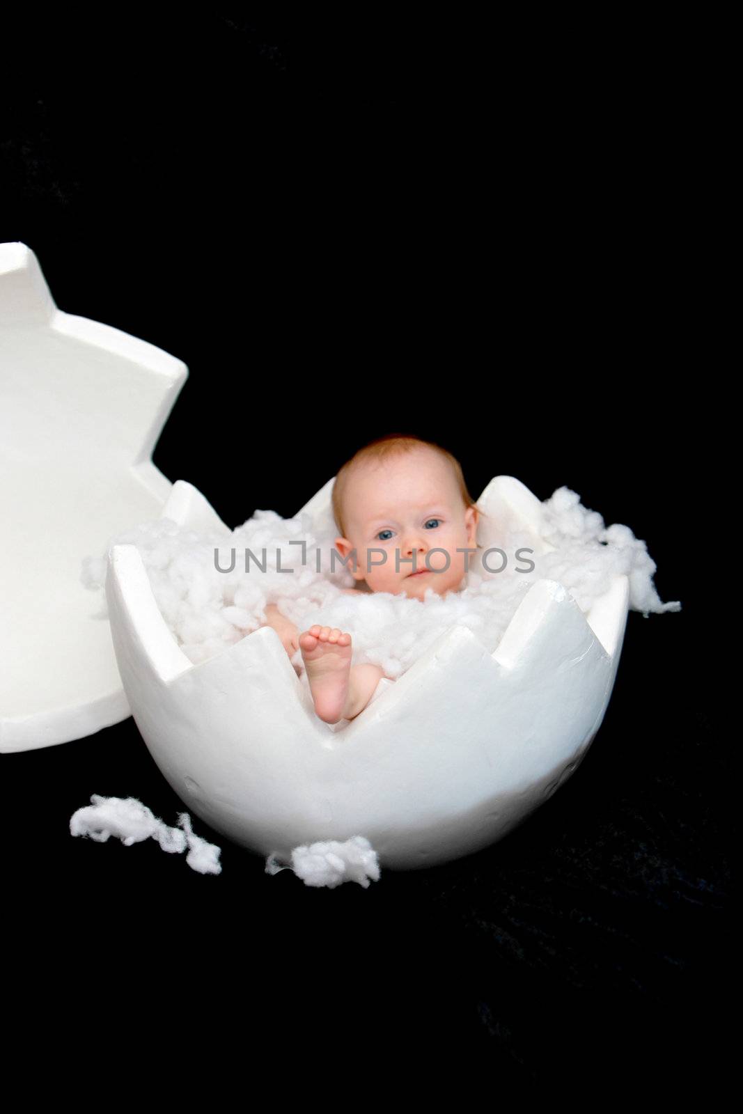 A baby sits in a large egg-shell by Farina6000