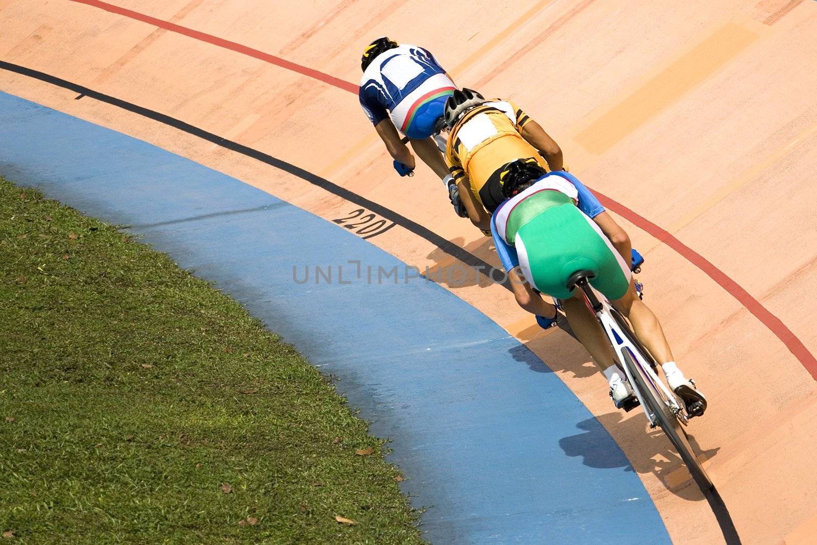 Image of participants in a cycling points race held at a velodrome.