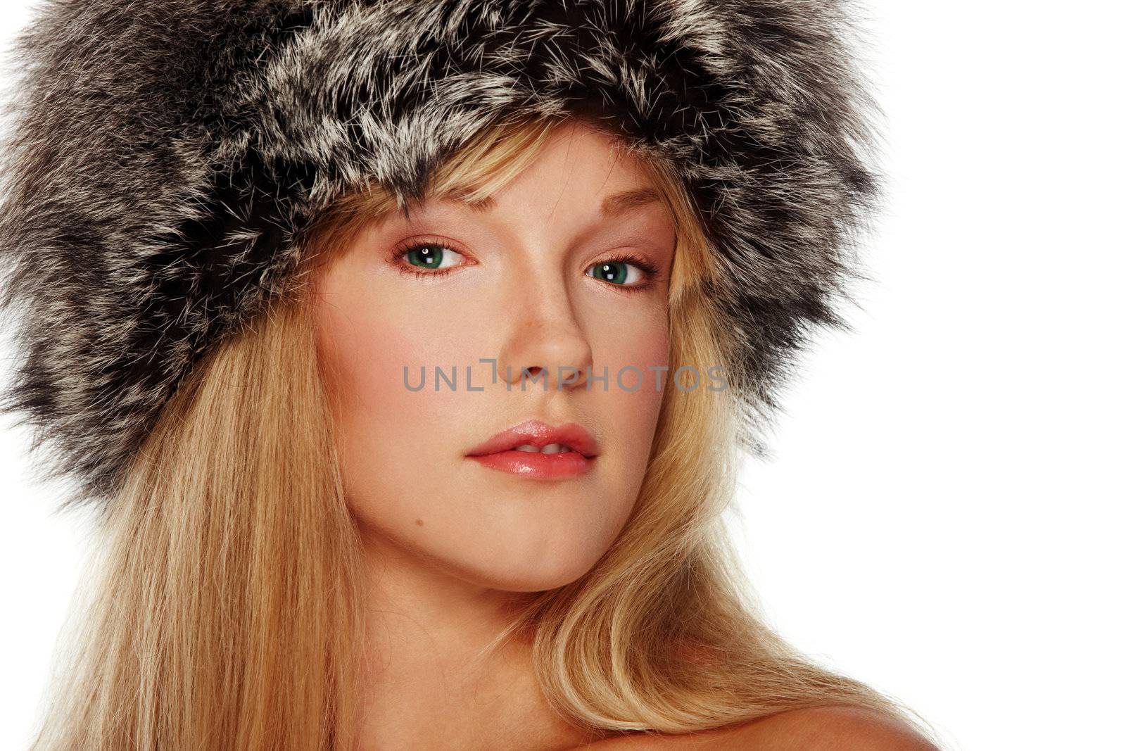 Portrait of girl in fur hat on isolated white background